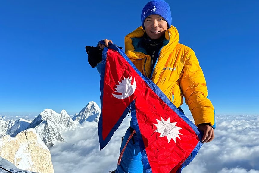 Mountaineer with a flag of Nepal