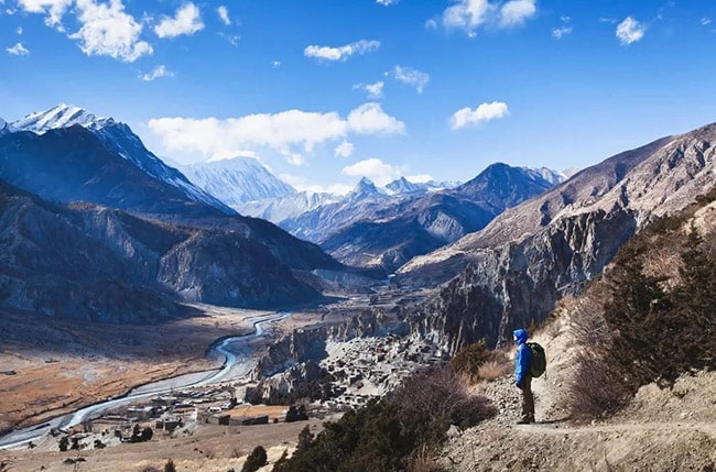 Trekker looking at the valley, Annapurna Circuit trek, Nepal